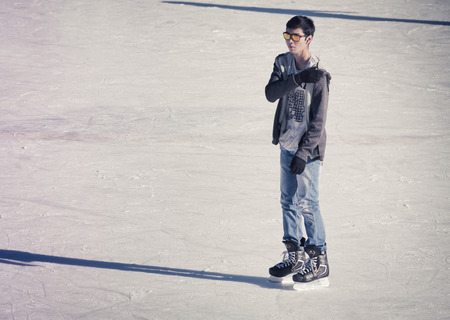 Image of young man who are ice skating at the ice rink outdoors at Medeoの写真素材