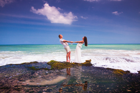 wedding couple holdings with hands near the beach, at small islandの写真素材