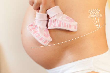 Pregnant woman with concept of walking baby to flowerの写真素材