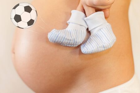 Pregnant woman with concept of football for baby professionの写真素材