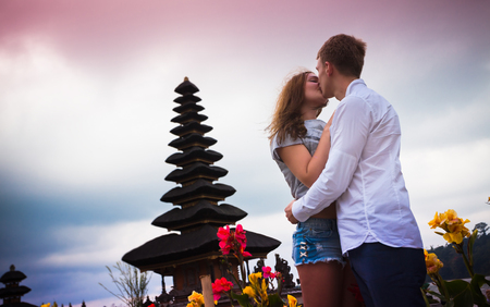 wedding couple near the famous temple at beratan lake, Baliの写真素材