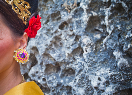 Mature woman wearing earrings and ornaments in Balinese styleの写真素材