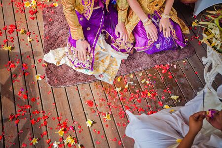 balinese wedding ceremony with sitting in the gazebo newlywedsの写真素材