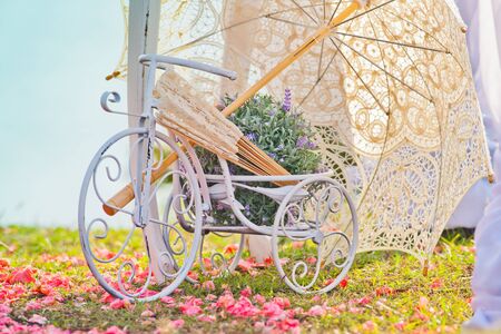 Wedding decoration of bicycle and umbrella at green grassの写真素材