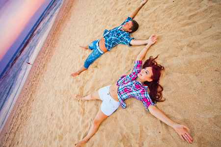 couple lying on the beach, Baliの写真素材