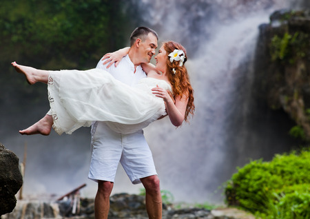 happy couple near waterfall, Baliの写真素材