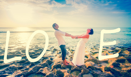 wedding couple just married near the beach with love textの写真素材