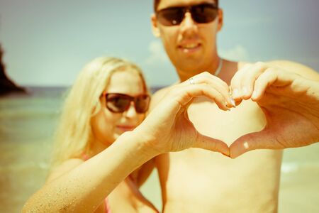 mature couple with love sign by handsの写真素材