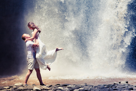 couple travel near the big waterfallの写真素材