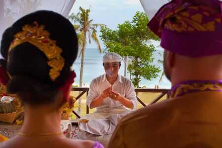balinese wedding ceremony with sitting in the gazebo newlywedsの写真素材