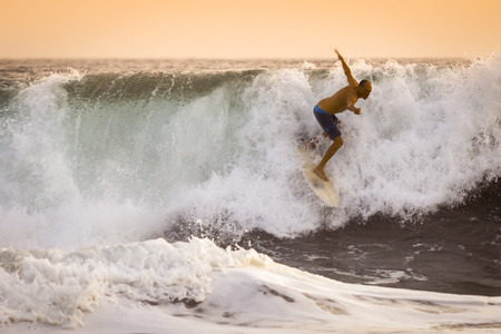 Surfer on wild Ocean Wave in Bali, Indonesia