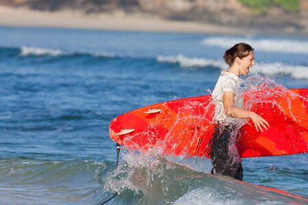 concept of outdoor businesswoman with surf near the ocean and  with copy space for any textの写真素材