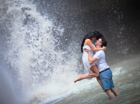 photo of couple travels to Indonesian waterfallの写真素材