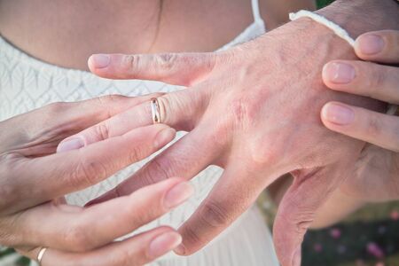 Wedding rings on hands of the newlyweds