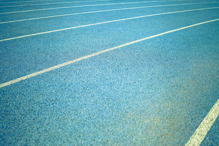 background of blue track for running competition at stadiumの写真素材