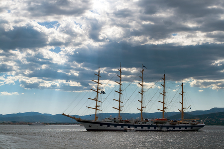 Picture of the ship is in waters of the Cote d'Azur near St Tropez. Punched through the cloud of beautiful rays of the sun.の写真素材