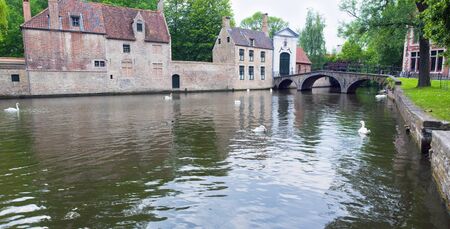 Image of a canal with a beautiful reflection in old part of town Bruges.の写真素材