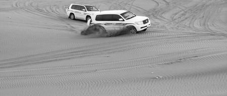 Black and white image of extreme driving jeeps safari on the sandのeditorial素材