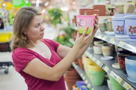 Image of a young woman who chooses underwear in the supermarket.の写真素材