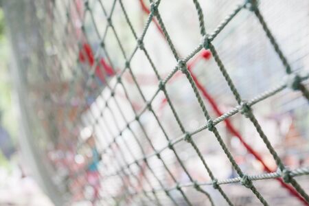 background of rope net in the children's rope park in the forest. Focus on foreground.