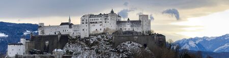 European old castle near the mountain at snowy winter in Austria, Salsburg. At Christmas eve.のeditorial素材