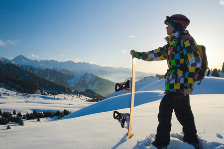 An image with snowboarder with a helmet and glasses on the background of high snow-mountain Alps in Grindelwald, Swissの写真素材