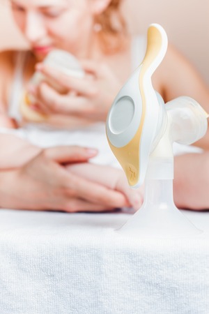 Manual breast pump and mother feedingの写真素材