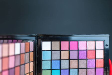 Professional cosmetic set with every color imaginable! Colorful palette for fashion makeup. Object at black background with copy spaceの写真素材