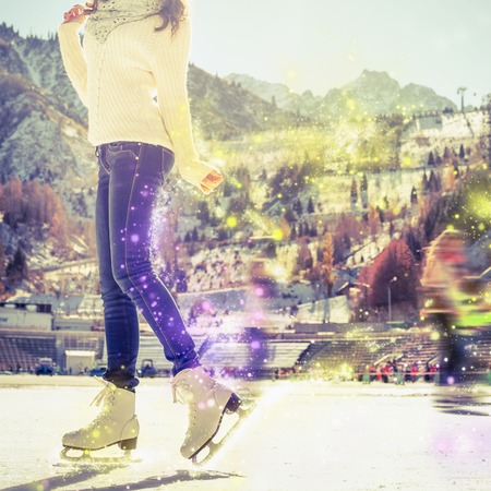 Young girl teenager elegantly posing and skating at the ice rink outdoor. Medeo stadium. Almaty. Winter activities for a good mood and healthy mind. Healthy lifestyle and sport conceptの写真素材