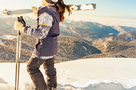 Ski adventure. Happy female skier on the background of high snow-capped Alps in Swiss. Healthy lifestyle and outdoor activityの写真素材