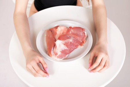 How to cook meat? Image of healthy eating. Woman cooking raw fresh meatの写真素材