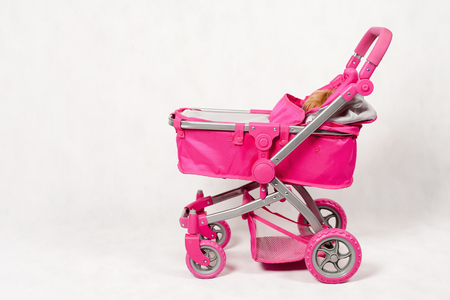 Pink baby stroller for play. Game. Baby carriage. Toy. Children's shop.の写真素材