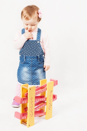 thinking baby girl playing with toy game for development. Child. Kindergarten activities. Kindercare learning center. Preschool educationの写真素材