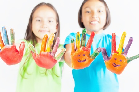 Happy kids with painted hands on a white background. International Children's Day. Painting, occupationの写真素材