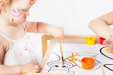 Mom and baby draws with colored inks. Games with child affect early development. Important to spend enough time with your kids.の写真素材
