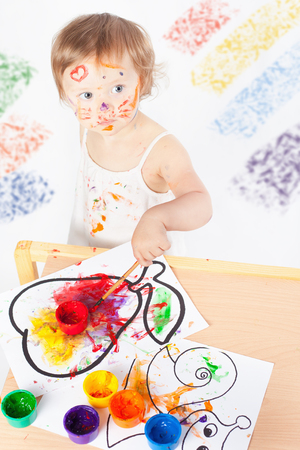 Baby draws with colored inks. Games with child affect early development. Important to spend enough time with your kids.の写真素材