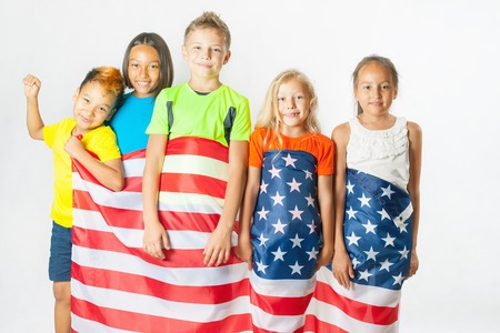 Funny kids holding american national flag. Group of school children. Multiethnic students. Friends. Fans, 2016. White backgroundのeditorial素材