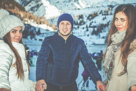 Funny teenagers girls and boy skating outdoor, ice rinkの写真素材