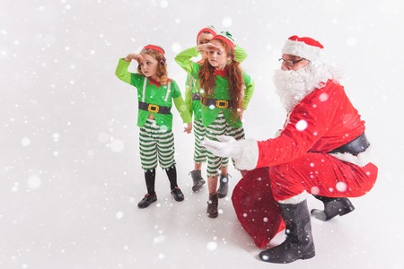 Santas helpers working at North Pole. He Reading wishes listの写真素材