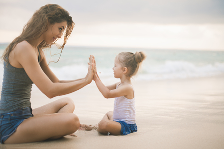 Mom and baby playing near beach. Traveling with family, childの写真素材