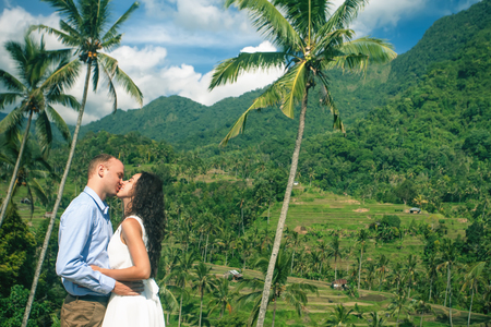 Happy couple kisses at the rice terraces. Traveling at Bali.の写真素材