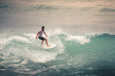 Surfer on Blue Ocean Wave, Bali, Indonesia. Riding in tube.の写真素材