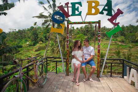 Happy couple walking at the rice terraces. Traveling at Bali.の写真素材