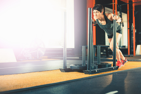 Attractive woman moving big weightの写真素材