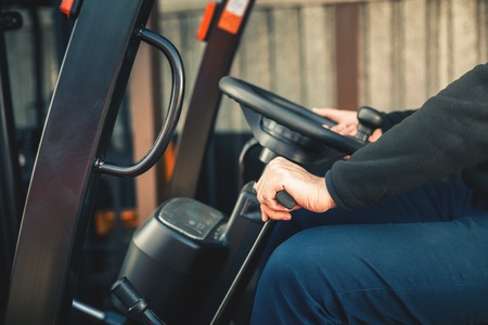 Closeup Man drives a reliable heavy truck loaderの写真素材
