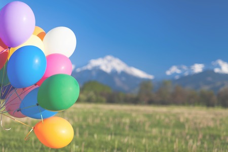 Multicolored balloons outdoor festival on blue sky backgroundの写真素材