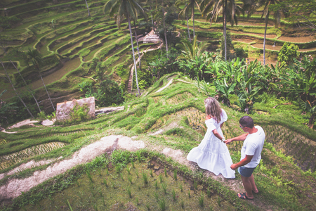 Happy couple traveling at Bali, rice terraces of Tegalalang, Ubud