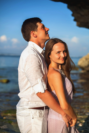 Portrait of happy couple, near the beach at background of sky.の写真素材