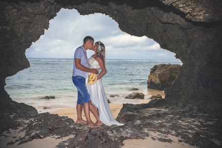 Portrait of happy successful couple, embracing in the Cave Baliの写真素材