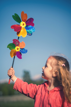 Concept image of happy child playing with windmill in Holland.の写真素材